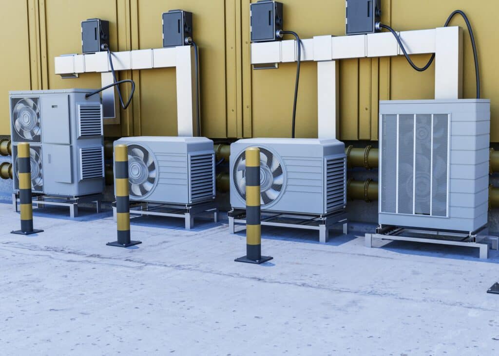 Close up of an outdoor heat pump unit beside a home